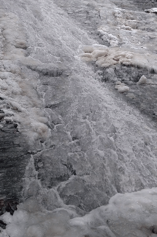 Water continues to flow through ice at Buttermilk Falls.
