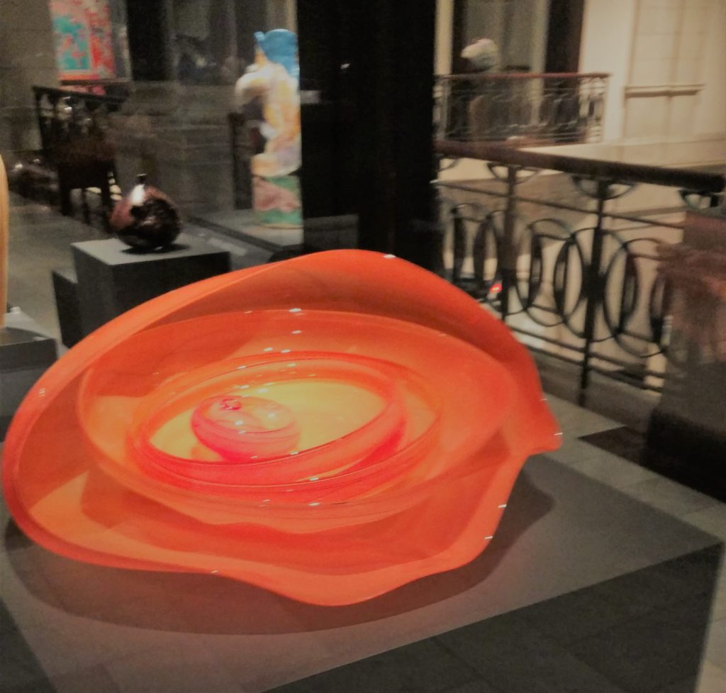 A colorful blown-glass sculpture fills a museum gallery.