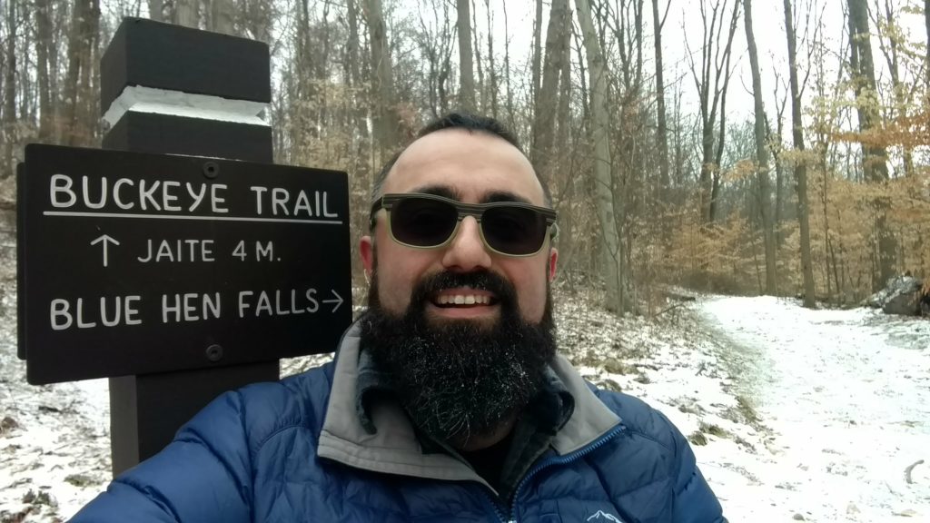 Andy smiles outdoors with frost on his beard.