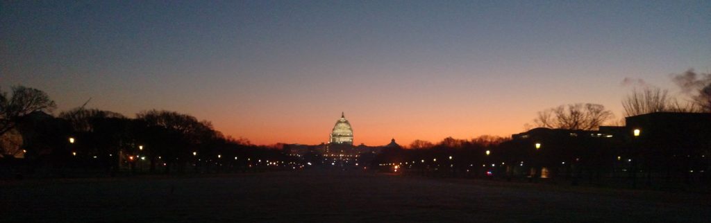 Sunrise light falls on the dome of the US Capitol.