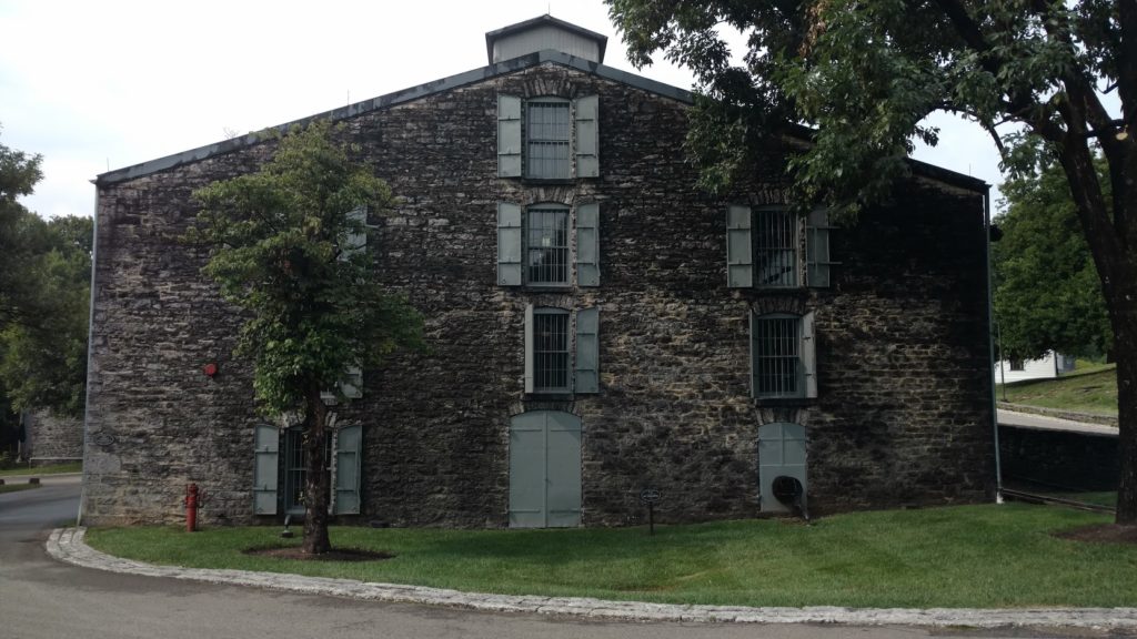 Woodford Reserve distillery campus surrounded by greenery.