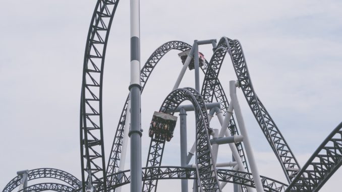 Person riding a roller coaster.