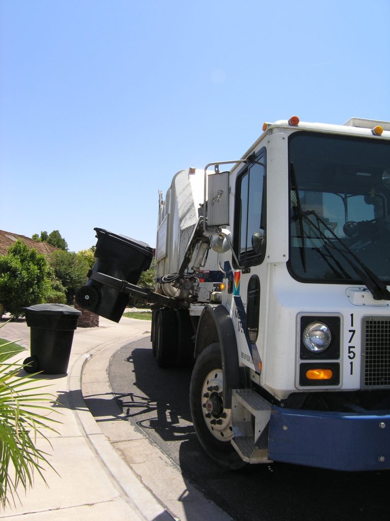 A garbage truck collecting trash, used as a metaphor for FILESTREAM garbage collection.